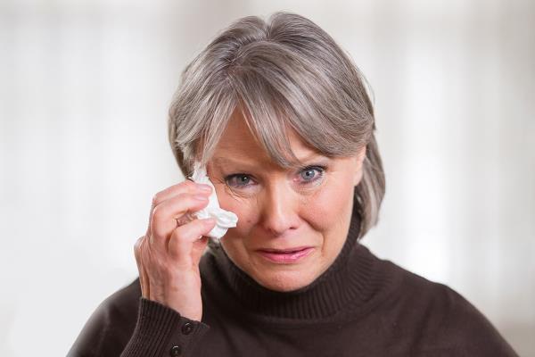 Woman wiping away tears