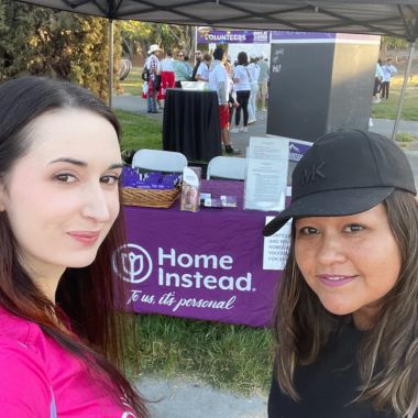 Home Instead Team Members with booth in background
