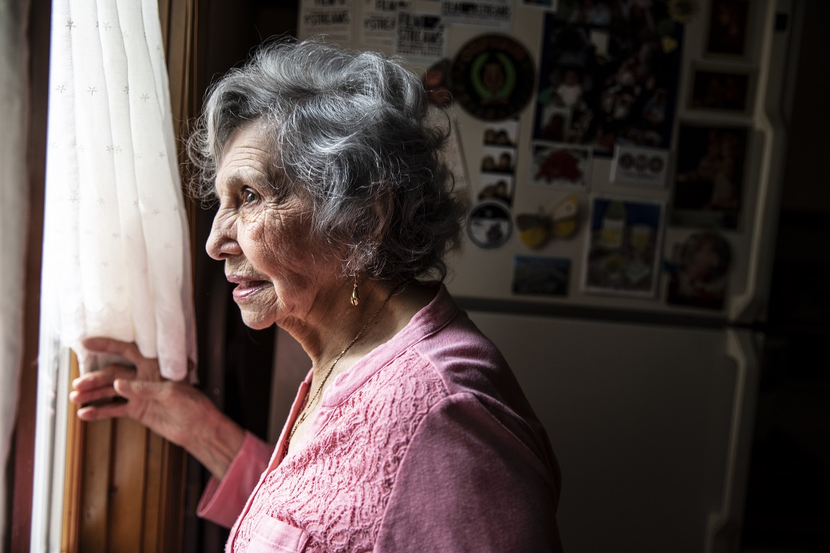 senior looking out window